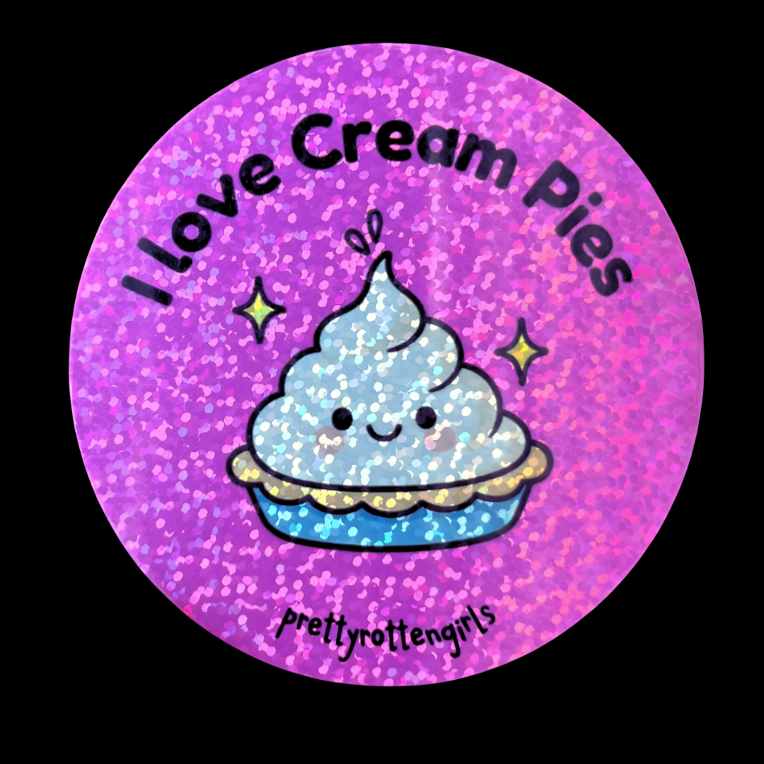 Circular sticker with a cartoon cream pie and 'I love cream pies' text on a purple glittery background.